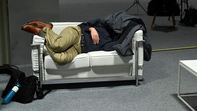 A man sleeps during the UN Climate Change Conference COP25 at the 'IFEMA - Feria de Madrid' exhibition centre, in Madrid. AFP