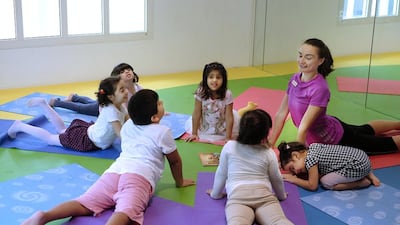 Viktoriya Kandyla leads a yoga class for some of the youngest campers at the Junior Gym during summer camp. Delores Johnson / The National