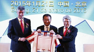 Atletico Madrid CEO Miguel Angel Gil, Wanda Group Chairman Wang Jianlin and Atletico President Enrique Cerezo hold a team jersey during an agreement ceremony in Beijing on January 21. China's Wanda Group officially announced it has invested 45-million euros to acquire a 20 percent stake in the club. Rolex Dela Pena/EPA