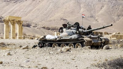 A Syrian army T-62 tank at the damaged site of the ancient city of Palmyra in central Syria. Louai Beshara / AFP