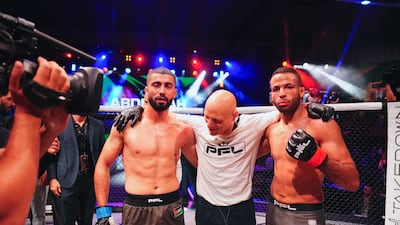 Abdullah Al Qahtani, right, celebrates alongside his beaten opponent Yazeed Hasanain, left.