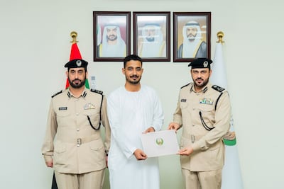 Brig Yousef Al Shamsi, director general of the Sharjah Civil Defence Authority, right, with Kassem Mohammed, centre. Photo: Sharjah Civil Defence Authority