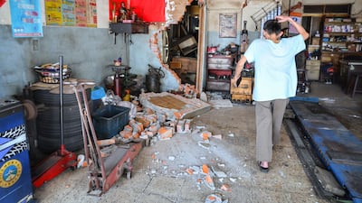 A man assesses damage in Taipei after the quake. AFP