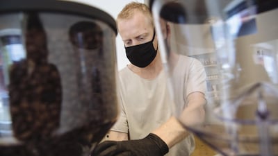 A worker wearing a protective mask grinds coffee at Breadfolks, a bakery and cafe, in Hudson, New York. Bloomberg