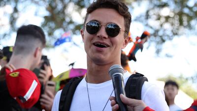 Lando Norris talks to the media after arriving at the track. Reuters