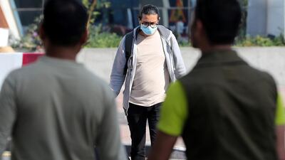 Some UAE residents, such as this man in Bur Dubai, are wearing face masks in the belief this will reduce the risk of catching coronavirus. Pawan Singh / The National