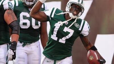The New York Jets’ Plaxico Burress celebrates his third touchdown against the San Diego Chargers.