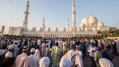 Worshippers celebrate Eid Al Fitr outside Sheikh Zayed Mosque early on Tuesday morning.