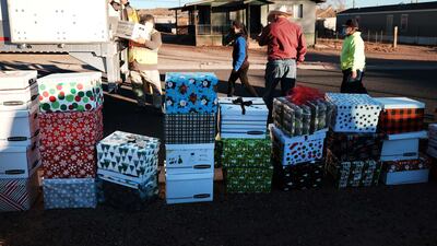 The event, which distributed food and other items to more than 250 families, was organised by the 'Walking in Beauty' foundation. Getty Images / AFP