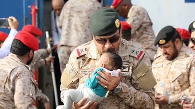 Saudi Navy personnel assist a child being evacuated by Saudi Arabia from Sudan to escape the conflicts, at Jeddah Sea Port, Jeddah, Saudi Arabia, April 26, 2023. Saudi Ministry of Defense / Handout via REUTERS ATTENTION EDITORS - THIS PICTURE WAS PROVIDED BY A THIRD PARTY