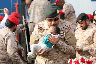 Saudi Navy personnel assist a child at Jeddah Sea Port. Photo: Saudi Ministry of Defence