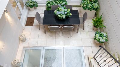 A patio leads off from the ground floor kitchen. Courtesy Vyomm.com