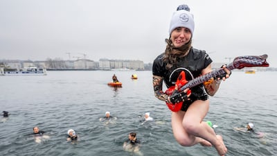 People jump into Lake Geneva during the 87th annual Christmas swimming 'Coupe de Noel' in Switzerland. More than 4,200 swimmers completed the 100-metre course in water temperatures of 8.8°C. EPA