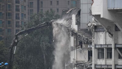 Workers demolish a seating area in the Workers' Stadium in Beijing. AFP