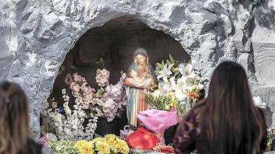 Worshippers take photos outside St Francis Church in Jebel Ali after Christmas Mass. Antonie Robertson / The National