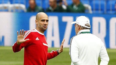 Bayern Munich manager Pep Guardiola, left, talks with assistant coach Hermann Gerland during their team's training session at Santiago Bernabeu stadium in Madrid, Spain on April 22, 2014. Bayern Munich will face Real Madrid in a Uefa Champions League semi final first leg match on Wednesday. EPA/BALLESTEROS