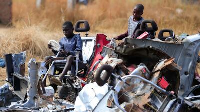 Children play at a scrap metal collection point in Hopley, a settlement about 15 kilometres west of Zimbabwe's capital, Harare. Reuters