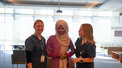 Nasriya Shure, centre, with staff at Sheikh Shakhbout Medical City in Abu Dhabi. Khushnum Bhandari / The National
