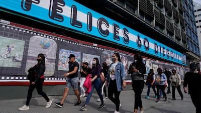 A billboard shows photos of former soccer star Diego Maradona below the Spanish message: "Merry 60, Diego" in Buenos Aires,. AP