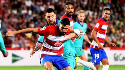 Granada midfielder Antonio Puertas in action against Barcelona forward Lionel Messi. EPA