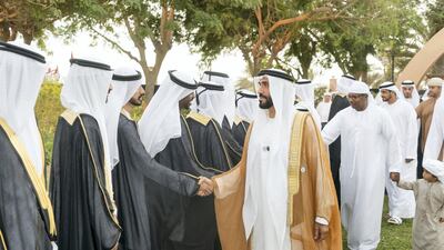 ABU DHABI, UNITED ARAB EMIRATES - November 27, 2018: HH Sheikh Nahyan Bin Zayed Al Nahyan, Chairman of the Board of Trustees of Zayed bin Sultan Al Nahyan Charitable and Humanitarian Foundation (R), greets a groom during a mass wedding reception of HH Sheikh Mohamed bin Khalifa bin Khaled Al Nahyan (not shown), at The Emirates Palace. ( Rashed Al Mansoori / Ministry of Presidential Affairs ) ---