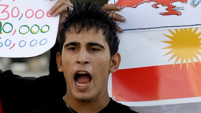 A Syrian Kurdish refugee holds a photo of Mashaal Tammo during a demonstration in Beirut on the first anniversary of his assassination. AP