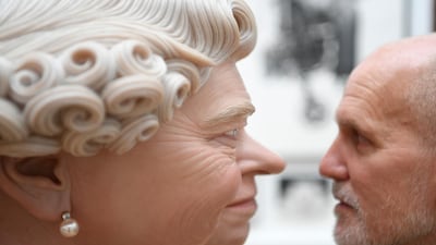 A man looks at the work 'The Queen' by artist John Humphries is displayed during the preview of Summer Exhibition at the Royal Academy of Arts in London. Neil Hall / EPA