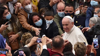 Pope Francis is greeted by worshippers at the end of the general audience in the Vatican. AFP