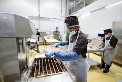 Chocolatiers Mumeen Abdul Wakkil (left) and Sajith Narayanan create hazelnut chocolate bars. Chris Whiteoak / The National