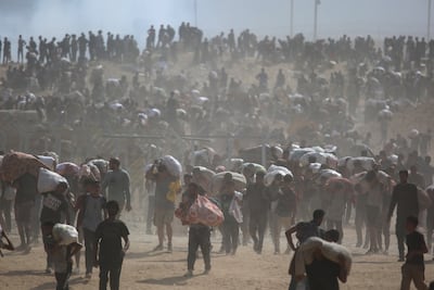 Palestinians carry aid supplies in central Gaza on August 4. Reuters
