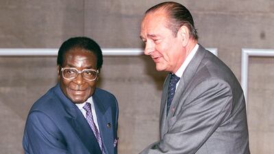French President Jacques Chirac greets his Zimbabwean counterpart Robert Mugabe at the opening of the 20th Franco-African summit in Paris on November 27, 1998. AFP