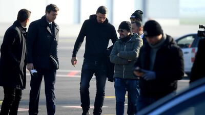 New AC Milan forward Zlatan Ibrahimovic is welcomed by officials. AFP