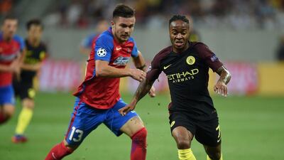 Raheem Sterling vies for the ball with Steaua Bucharest defender Alin Tosca. (AFP)