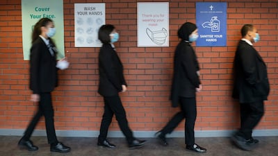 Pupils queue for a socially distanced school assembly in Manchester, England. AP