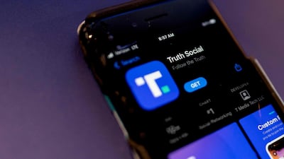 A phone screen displays the Truth Social app. AFP