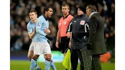 Carlos Tevez exchanges words with Roberto Mancini after being substituted this month.