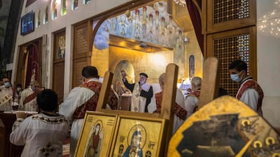 Coptic priest Athnaceyous leads Christmas Mass at the Archangel Michael Coptic Orthodox Church. AFP