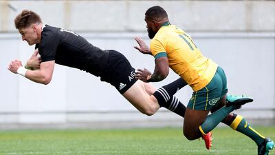 Australia's Marika Koroibete (R) tackles New Zealand's Jordie Barrett as he scores a try during the Bledisloe Cup rugby union match between New Zealand and Australia in Wellington. AFP