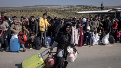 A displaced Syrian woman walks towards Turkey's Cilvegozu border crossing to Bab Al Hawa in Syria on Thursday. Getty