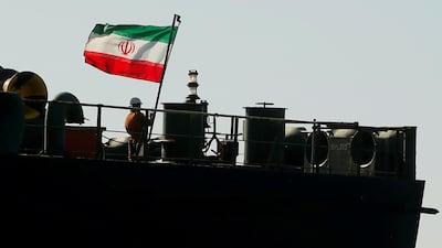 A crew member raises the Iranian flag on oil tanker Adrian Darya 1, previously named Grace 1. REUTERS/Jon Nazca