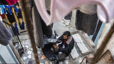 Abu Raida assembles an electric vehicle at his workshop. AFP