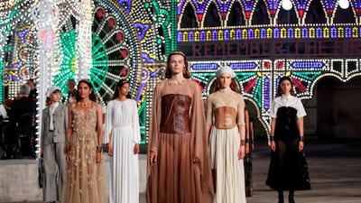 Models present creations from Dior's Cruise 2021 collection during a live-streamed runway show without an audience at Piazza del Duomo, in Lecce, Italy. Reuters