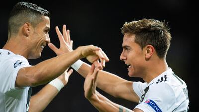 Paulo Dybala, right, is congratulated by Cristiano Ronaldo after giving Juventus the lead. Reuters