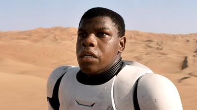 In this image released by Disney, a scene is shown from the upcoming film, "Star Wars: The Force Awakens," expected in theaters on Dec. 18, 2015. John Boyega plays a force-sensitive storm trooper who defects from The Empire and winds up stranded on Tatooine and hunted as a deserter.(AP Photo/LucasFilm, Disney)