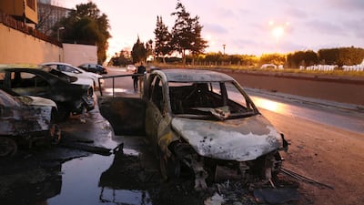 Burned cars are seen at the headquarters of Libya's foreign ministry after suicide attackers hit in Tripoli. REUTERS