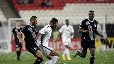 Ali Mabkhout of Al Jazira holds off Nader Belhadj of Al Sadd in their Asian Champions League match. Jeffrey E Biteng / The National