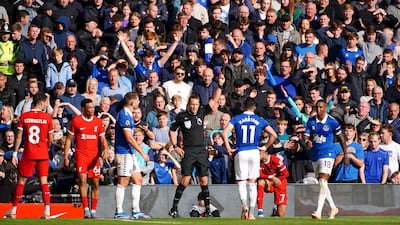 Everton’s Ashley Young is shown a red card by referee Craig Pawson. PA