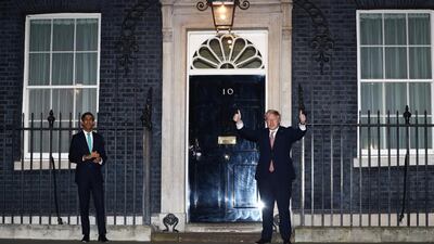 Britain's Prime Minister Boris Johnson and Chancellor of the Exchequer Rishi Sunak outside 10 Downing Street during the Clap For Our Carers campaign in support of the NHS, as the spread of the coronavirus disease (COVID-19) continues. REUTERS/Hannah McKay