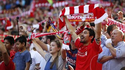 Liverpool fans hold up scarves before the start of the match. John Sibley / Reuters