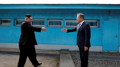 South Korean President Moon Jae-in (right) and North Korean leader Kim Jong-un shaking hands at the truce village of Panmunjom inside the demilitarised zone separating the two Koreas / Korea summit press pool via Reuters
